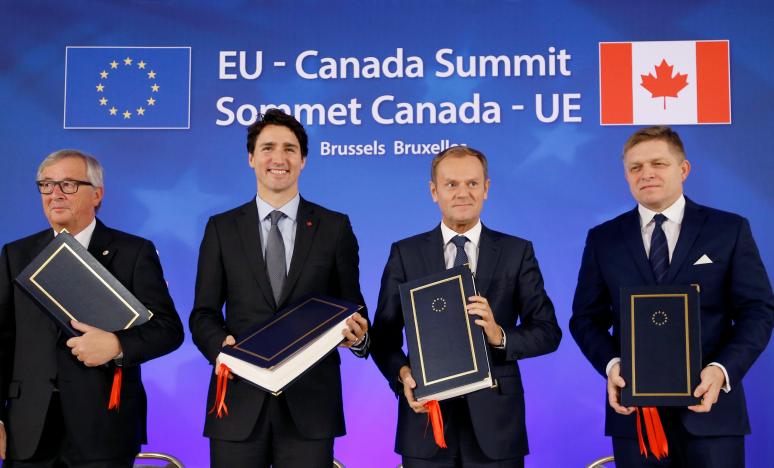 EU, Canada sign free trade deal but battle not over