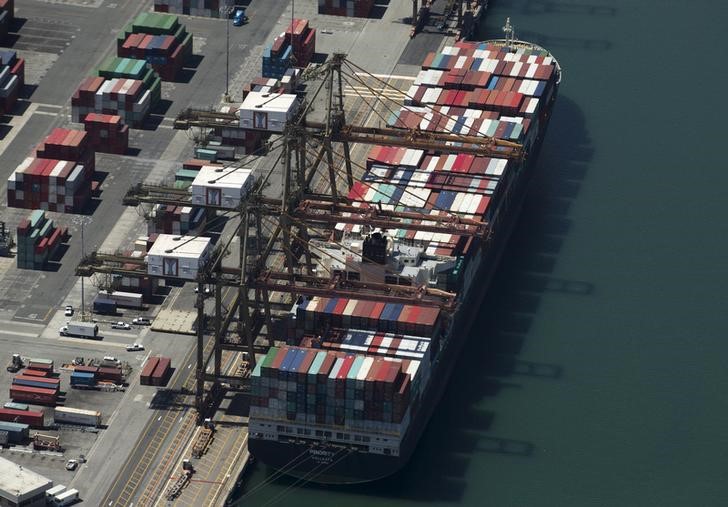 U.S. economy slows on wider trade gap; business spending rises